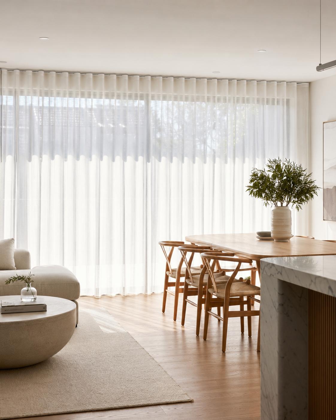 Sheer curtains in a bright modern living room